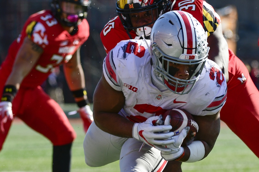 Nov 17, 2018; College Park, MD, USA; Ohio State Buckeyes running back J.K. Dobbins (2) dives for extra yards as Maryland Terrapins linebacker Durell Nchami (30) defends at Capital One Field at Maryland Stadium. Mandatory Credit: Tommy Gilligan-USA TODAY Sports