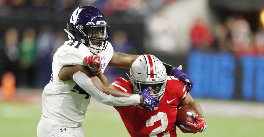 Dec 1, 2018; Indianapolis, IN, USA; Ohio State Buckeyes running back J.K. Dobbins (2) is tackled by Northwestern Wildcats safety Jared McGee (41) during the fourth quarter in the Big Ten conference championship game at Lucas Oil Stadium. Mandatory Credit: Brian Spurlock-USA TODAY Sports