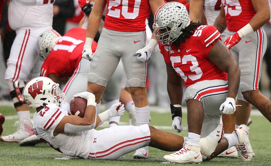 Oct 26, 2019; Columbus, OH, USA; Ohio State Buckeyes defensive tackle Davon Hamilton (53) stops Wisconsin Badgers running back Jonathan Taylor (23) for no gain during the first quarter at Ohio Stadium. Mandatory Credit: Joe Maiorana-USA TODAY Sports