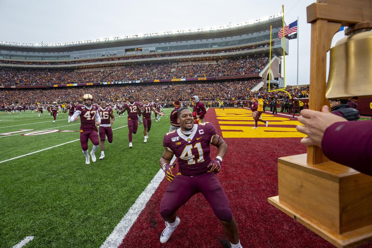 Nov 9, 2019; Minneapolis, MN, USA; Minnesota Golden Gophers linebacker Thomas Barber (41) runs to get the Governor Liberty Bell trophy after defeating the Penn State Nittany Lions at TCF Bank Stadium. Mandatory Credit: Jesse Johnson-USA TODAY Sports