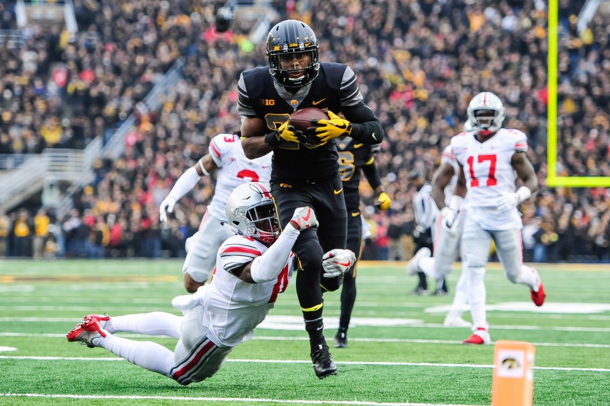 Nov 4, 2017; Iowa City, IA, USA; Iowa Hawkeyes running back Akrum Wadley (25) runs the ball as Ohio State Buckeyes cornerback Jordan Fuller (4) attempts a tackle during the second quarter at Kinnick Stadium. Mandatory Credit: Jeffrey Becker-USA TODAY Sports