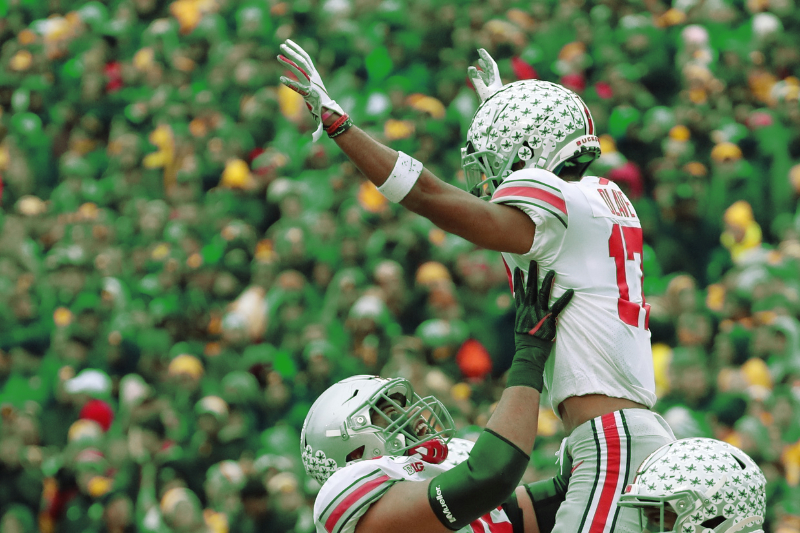 Nov 30, 2019; Ann Arbor, MI, USA; Ohio State Buckeyes wide receiver Chris Olave (17) if lifted in the air by offensive lineman Branden Bowen (76) in the first half at Michigan Stadium. Mandatory Credit: Rick Osentoski-USA TODAY Sports