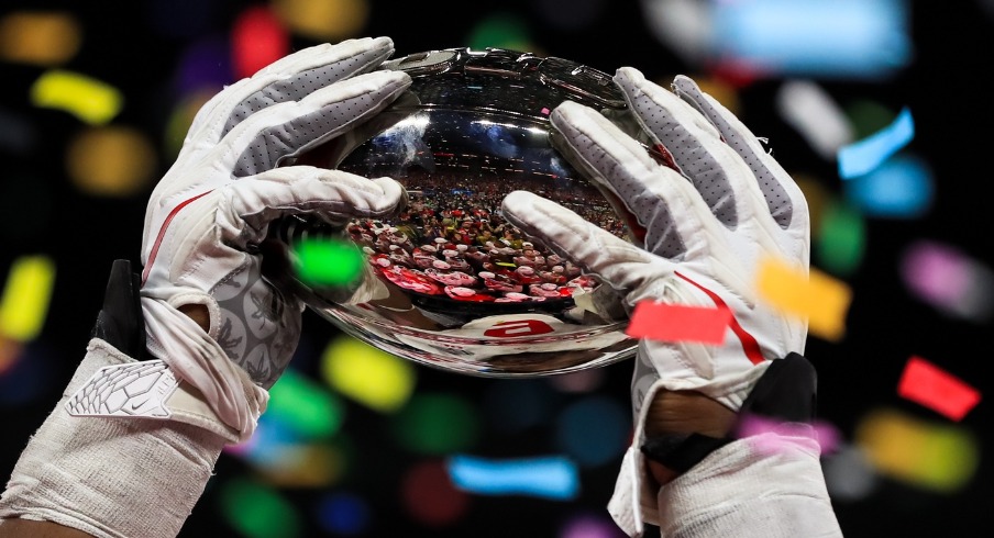 Dec 7, 2019; Indianapolis, IN, USA; A member of the Ohio State Buckeyes holds the Big Ten Championship Trophy after defeating the Wisconsin Badgers in the 2019 Big Ten Championship Game at Lucas Oil Stadium. Mandatory Credit: Aaron Doster-USA TODAY Sports