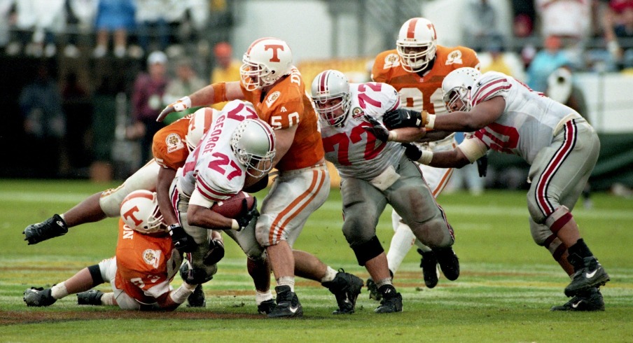 Heisman Trophy winner Eddie George (27) of Ohio State is dragged down by a trio of Tennessee defenders during the Citrus Bowl game in Orlando, Fla., Jan. 1, 1996. Tennessee came out on top 20-14.