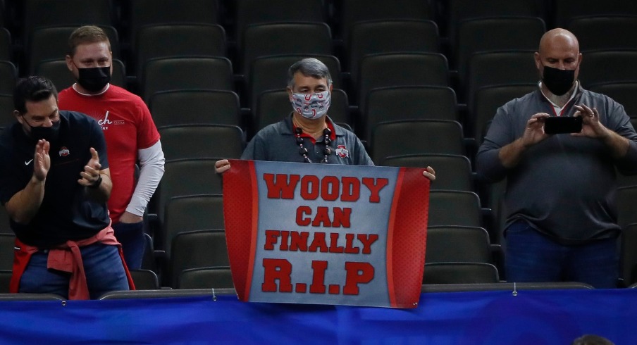 An Ohio State fan holds a sign for Woody Hayes as Buckeyes players leave the field following their 49-28 win over the Clemson Tigers in the College Football Playoff semifinal at the Allstate Sugar Bowl in the Mercedes-Benz Superdome in New Orleans on Friday, Jan. 1, 2021. College Football Playoff Ohio State Faces Clemson In Sugar Bowl