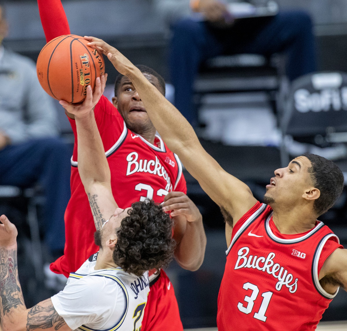 Ohio State Buckeyes forward Seth Towns (31) gets a block on Michigan Wolverines forward Brandon Johns Jr. (23) on Saturday, March 13, 2021, during the men's Big Ten basketball tournament from Lucas Oil Stadium. Ohio State Buckeyes beat Michigan Wolverines 68-67.