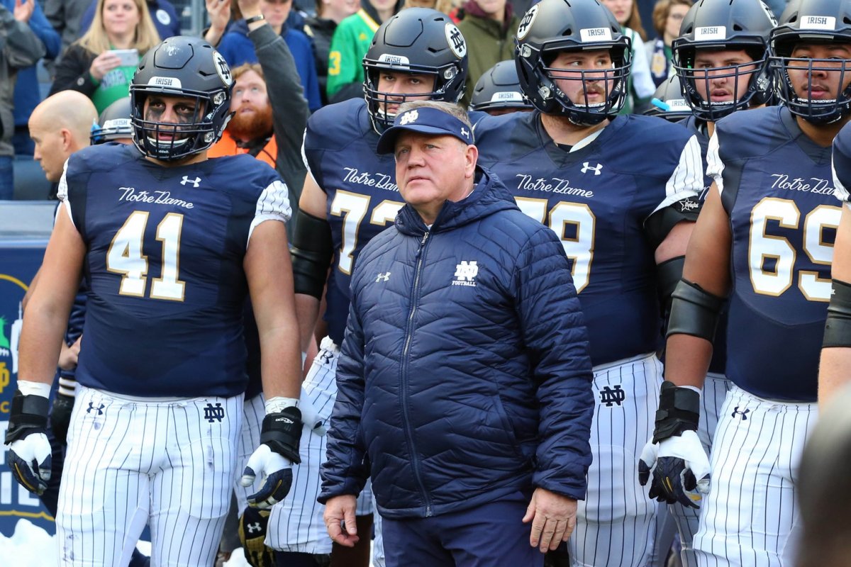 Nov 17, 2018; New York, NY, USA; Notre Dame Fighting Irish head coach Brian Kelly stands with his team prior to running on the field for the game against the Syracuse Orange at Yankee Stadium. Mandatory Credit: Rich Barnes-USA TODAY Sports