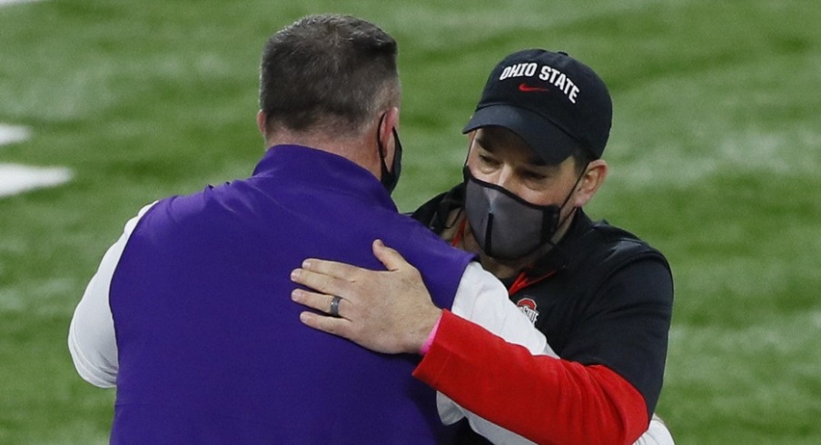 Northwestern Wildcats head coach Pat Fitzgerald hugs Ohio State Buckeyes head coach Ryan Day prior to the Big Ten Championship football game at Lucas Oil Stadium in Indianapolis on Saturday, Dec. 19, 2020. Big Ten Championship Ohio State Northwestern Northwestern Wildcats head coach Pat Fitzgerald hugs Ohio State Buckeyes head coach Ryan Day prior to the Big Ten Championship football game at Lucas Oil Stadium in Indianapolis on Saturday, Dec. 19, 2020. Big Ten Championship Ohio State Northwestern