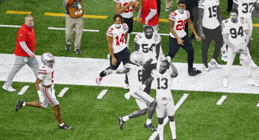 Jan 1, 2021; New Orleans, LA, USA; Ohio State Buckeyes wide receiver Jameson Williams (6) celebrates after scoring a touchdown against the Clemson Tigers with Ohio State Buckeyes cornerback Tyreke Johnson (13) during the fourth quarter at Mercedes-Benz Superdome