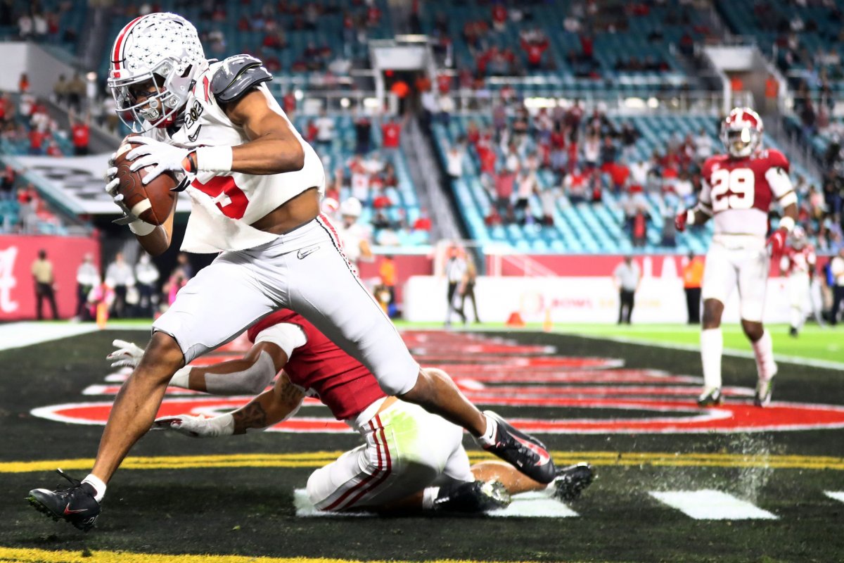 Jan 11, 2021; Miami Gardens, Florida, USA; Ohio State Buckeyes wide receiver Garrett Wilson (5) catches a pass for a touchdown against Alabama Crimson Tide defensive back Brian Branch (14) during the third quarter in the 2021 College Football Playoff National Championship Game. Mandatory Credit: Mark J. Rebilas-USA TODAY Sports