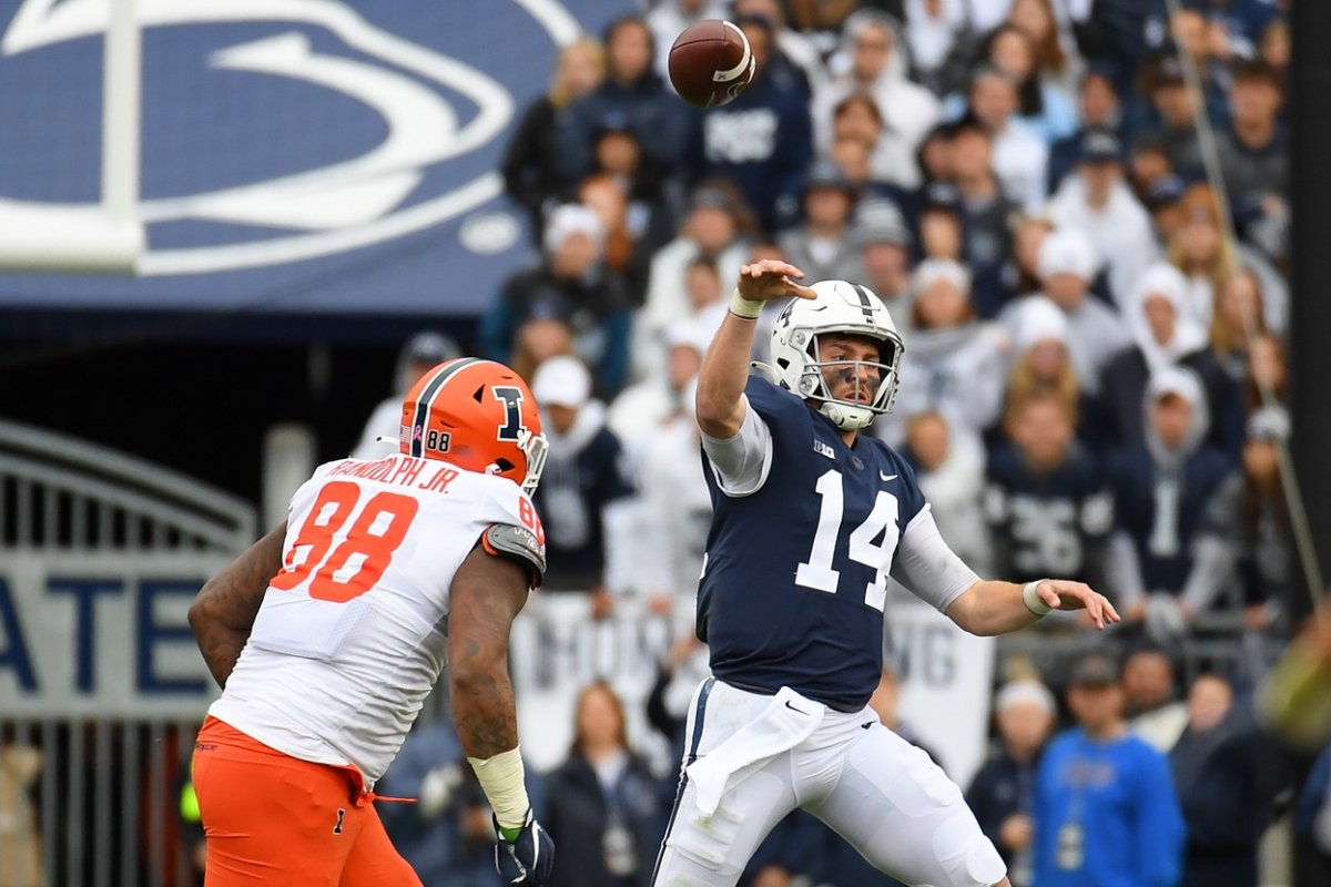 Oct 23, 2021; University Park, Pennsylvania, USA; Penn State Nittany Lions quarterback Sean Clifford (14) passes the ball as Illinois Fighting Illini defensive lineman Keith Randolph Jr. (88) pressures during the second half at Beaver Stadium. Mandatory Credit: Rich Barnes-USA TODAY Sports