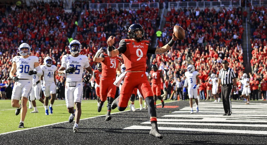 Nov 6, 2021; Cincinnati, Ohio, USA; Cincinnati Bearcats quarterback Desmond Ridder (9) runs with the ball for a touchdown against the Tulsa Golden Hurricane in the first half at Nippert Stadium. Mandatory Credit: Aaron Doster-USA TODAY Sports