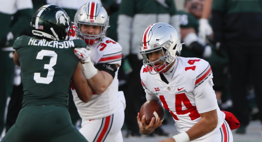 Ohio State Buckeyes quarterback C.J. Stroud (14) runs the ball during the fourth quarter of a NCAA Division I football game between the Michigan State Spartans and the Ohio State Buckeyes on Saturday, Dec. 5, 2020 at Spartan Stadium in East Lansing, Michigan. Ohio State Buckeyes quarterback C.J. Stroud (14) runs the ball during the fourth quarter of a NCAA Division I football game between the Michigan State Spartans and the Ohio State Buckeyes on Saturday, Dec. 5, 2020 at Spartan Stadium in East Lansing, Michigan.