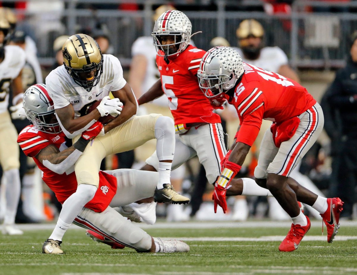 Ohio State Buckeyes linebacker Steele Chambers (22) tackles Purdue Boilermakers wide receiver Milton Wright (0) after a catch during the 1st quarter of their NCAA game at Ohio Stadium in Columbus, Ohio on November 13, 2021. 