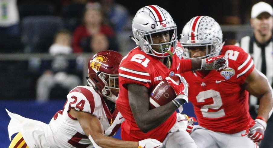 Ohio State Buckeyes wide receiver Parris Campbell (21) runs the ball as USC Trojans cornerback Isaiah Langley (24) tackles during the third quarter of the Goodyear Cotton Bowl Classic between the Ohio State Buckeyes and the USC Trojans on Friday, December 29, 2017 at AT&T Stadium in Arlington