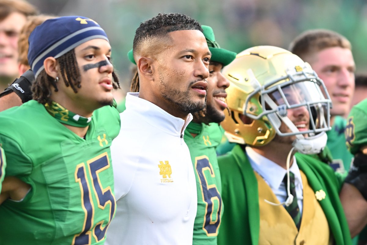 Notre Dame head coach Marcus Freeman alongside players and mascot
