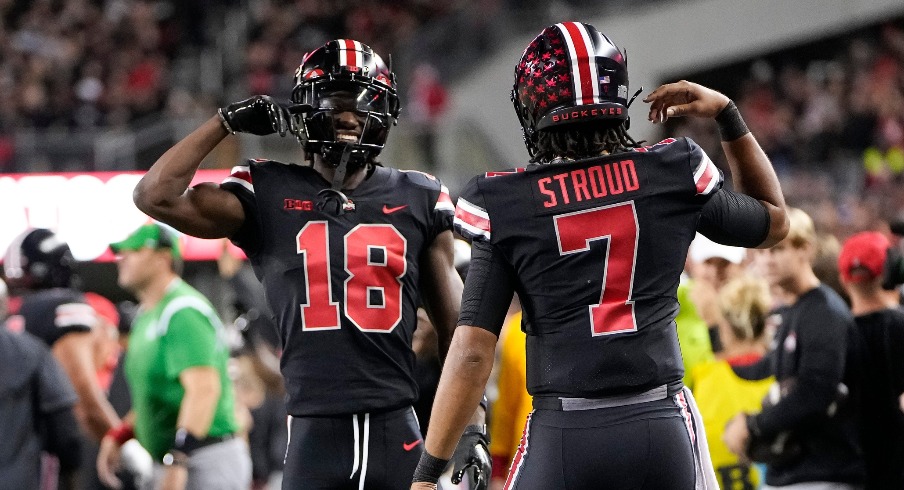 Sep 24, 2022; Columbus, Ohio, USA; Ohio State Buckeyes quarterback C.J. Stroud (7) celebrates a touchdown with wide receiver Marvin Harrison Jr. (18) during the first half of the NCAA Division I football game against the Wisconsin Badgers at Ohio Stadium. Mandatory Credit: Adam Cairns-