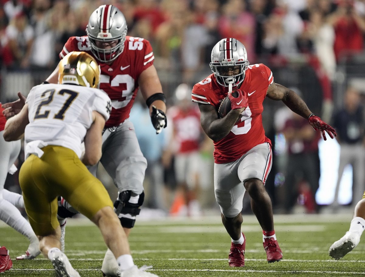 Sep 3, 2022; Columbus, Ohio, USA; Ohio State Buckeyes running back Miyan Williams (3) carries the ball behind offensive lineman Luke Wypler (53) against Notre Dame Fighting Irish linebacker JD Bertrand (27) in the fourth quarter at Ohio Stadium. Mandatory Credit: Kyle Robertson-USA TODAY Sports