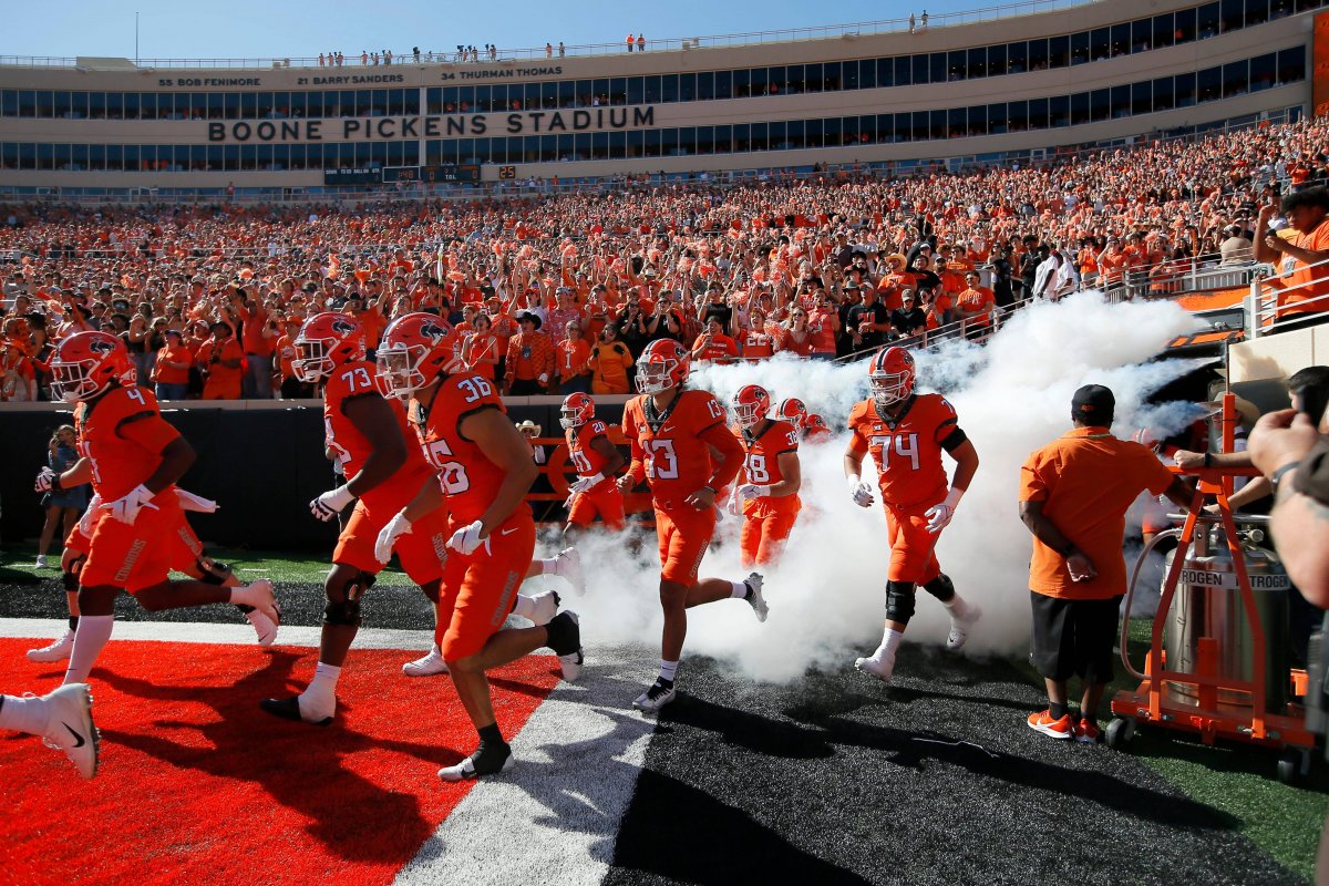 The Oklahoma State Cowboys run onto the field at Boone Pickens Stadium
