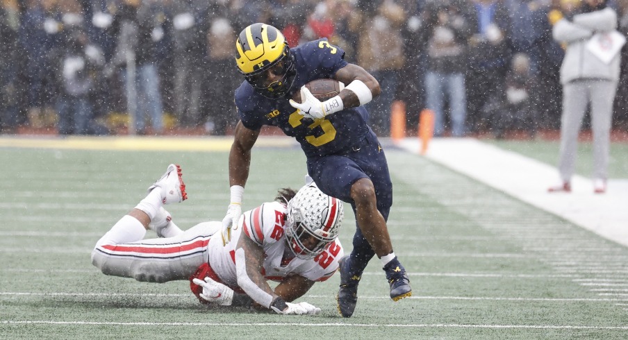 Nov 27, 2021; Ann Arbor, Michigan, USA; Michigan Wolverines wide receiver A.J. Henning (3) rush the ball passed Ohio State Buckeyes linebacker Steele Chambers (22) in the first half at Michigan Stadium. Mandatory Credit: Rick Osentoski-USA TODAY Sports