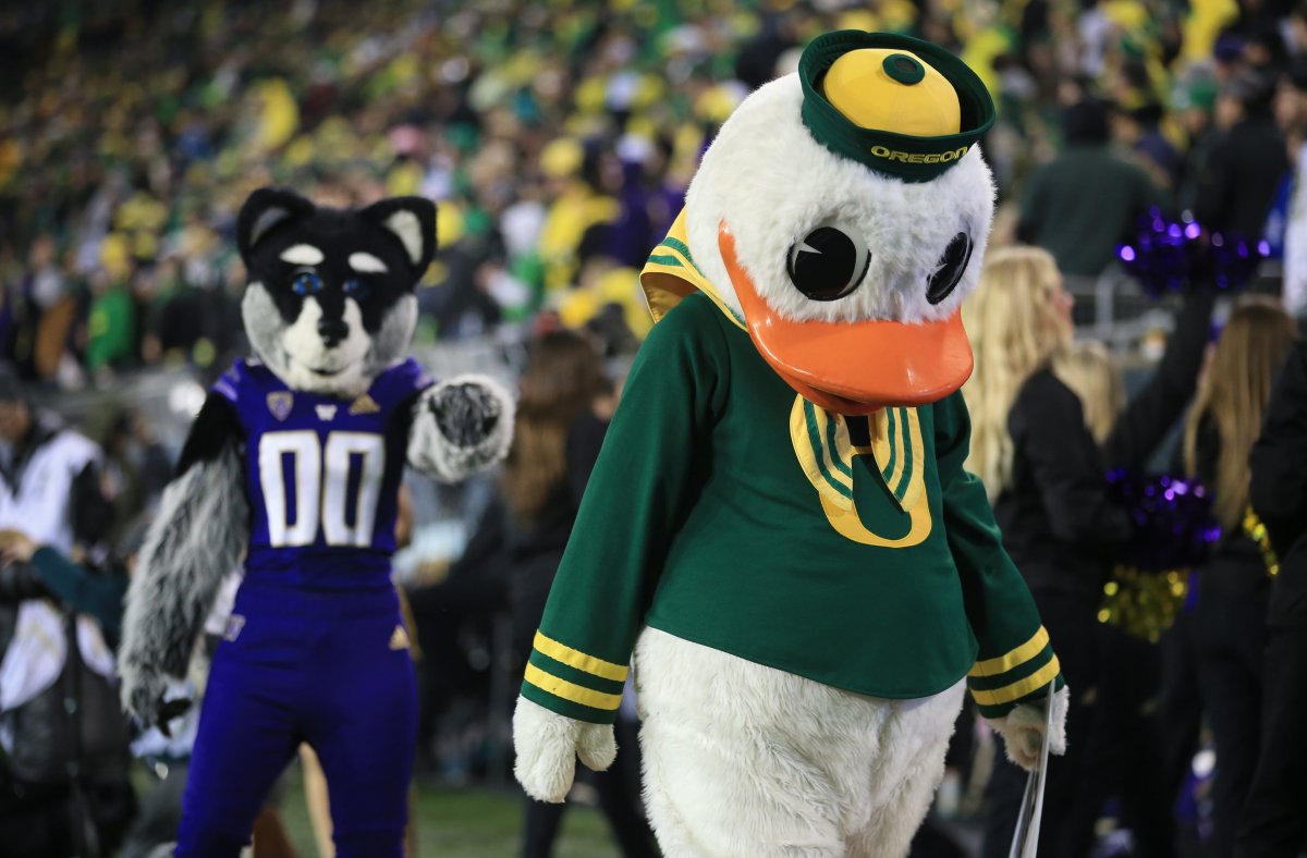 Harry the Husky of the Washington Huskies Points and Laughs at The Oregon Duck of the Oregon Ducks
