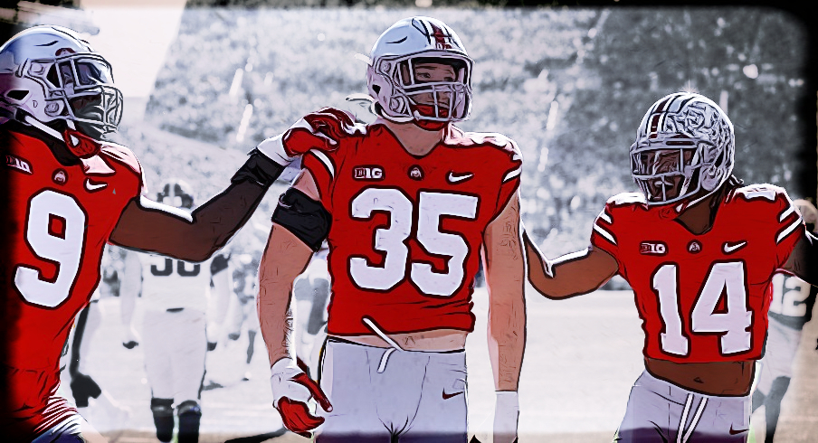 Oct 22, 2022; Columbus, Ohio, USA; Ohio State Buckeyes linebacker Tommy Eichenberg (35) celebrates his interception return for a touchdown with safety Ronnie Hickman (14) and defensive end Zach Harrison (9) during the second quarter against the Iowa Hawkeyes at Ohio Stadium. Mandatory Credit: Joseph Maiorana-USA TODAY Sports