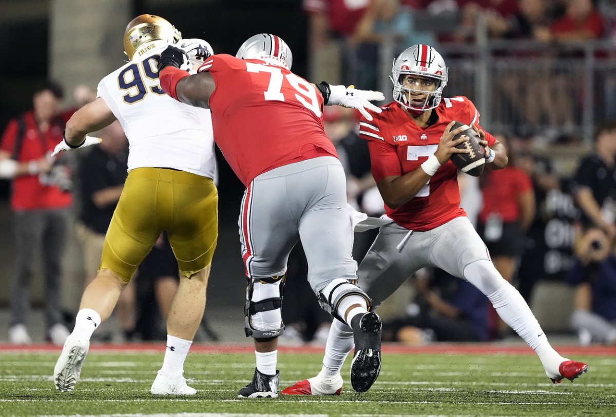 Sep 3, 2022; Columbus, Ohio, USA; Ohio State Buckeyes quarterback C.J. Stroud (7) avoids pressure from Notre Dame Fighting Irish defensive lineman Rylie Mills (99) as Ohio State offensive lineman Dawand Jones (79) blocks in the third quarter at Ohio Stadium. Mandatory Credit: Kyle Robertson-USA TODAY Sports