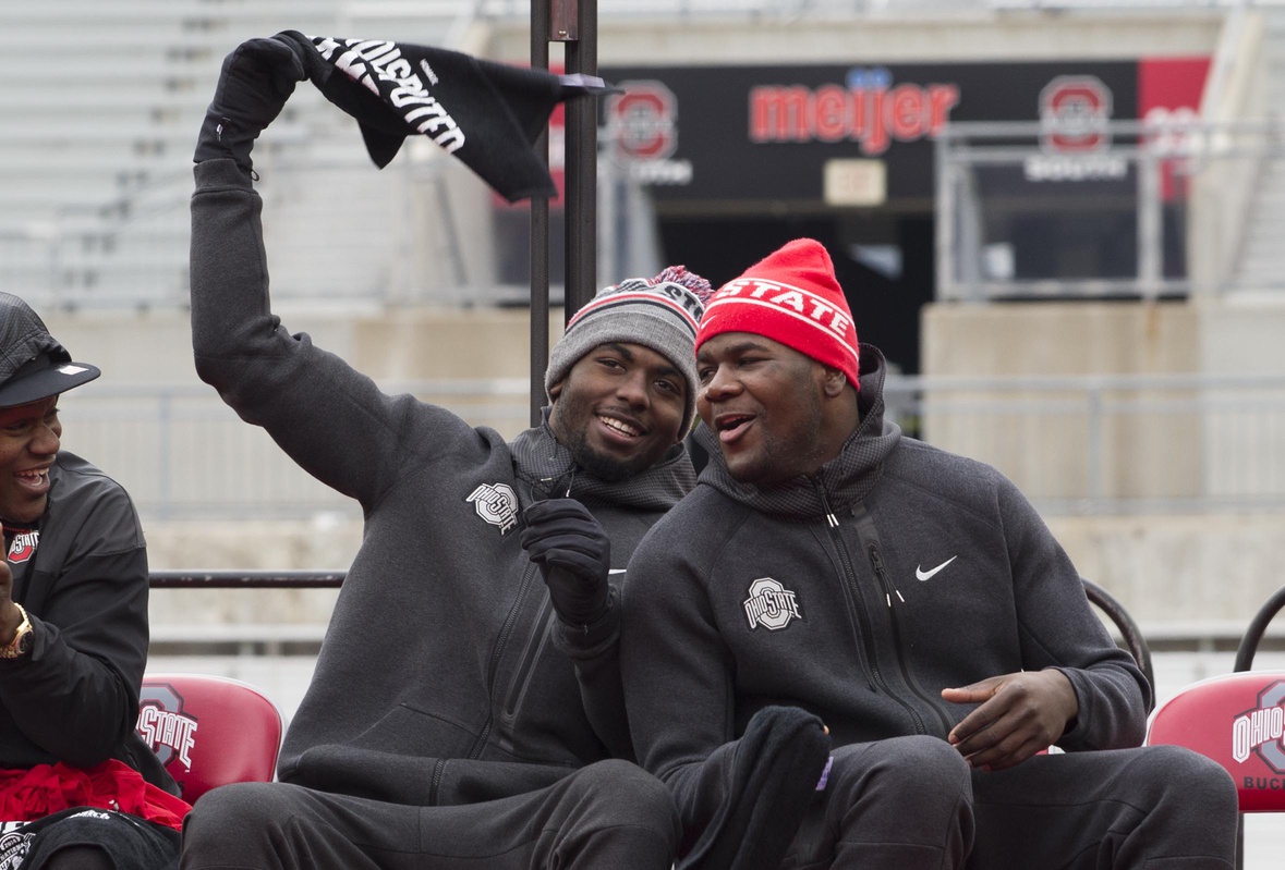 Jan 24, 2015; Columbus, OH, USA; Ohio State Buckeyes quarterbacks J.T. Barrett (16) and Cardale Jones (12) react as quarterback Braxton Miller (5) is introduced during the National Championship celebration at Ohio Stadium. Mandatory Credit: Greg Bartram-USA TODAY Sports