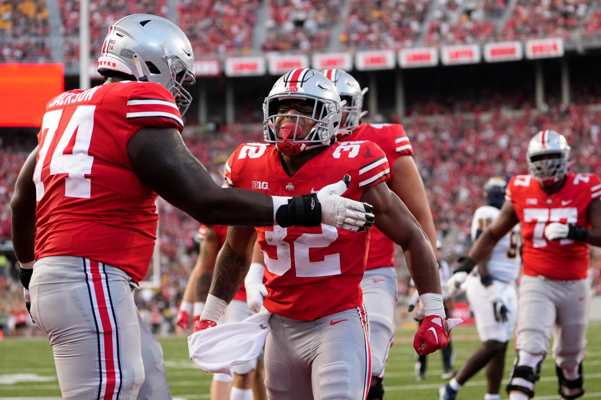 Sep 17, 2022; Columbus, Ohio, USA; Ohio State Buckeyes running back TreVeyon Henderson (32) celebrates scoring a touchdown with offensive lineman Donovan Jackson (74) during the first half of the NCAA Division I football game against the Toledo Rockets at Ohio Stadium. Mandatory Credit: Adam Cairns-The Columbus Dispatch Ncaa Football Toledo Rockets At Ohio State Buckeyes