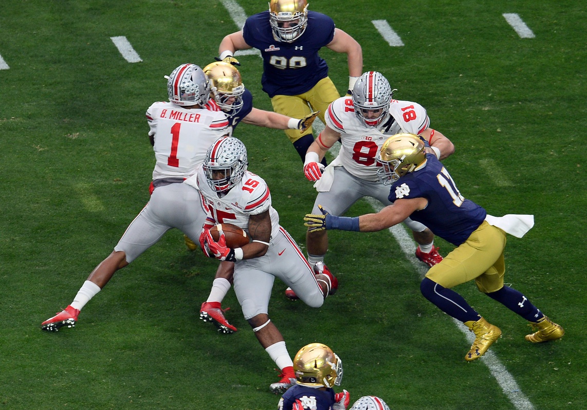 Jan 1, 2016; Glendale, AZ, USA; Ohio State Buckeyes running back Ezekiel Elliott (15) runs with the ball against the Notre Dame Fighting Irish during the first half of the 2016 Fiesta Bowl at University of Phoenix Stadium. Mandatory Credit: Joe Camporeale-USA TODAY Sports