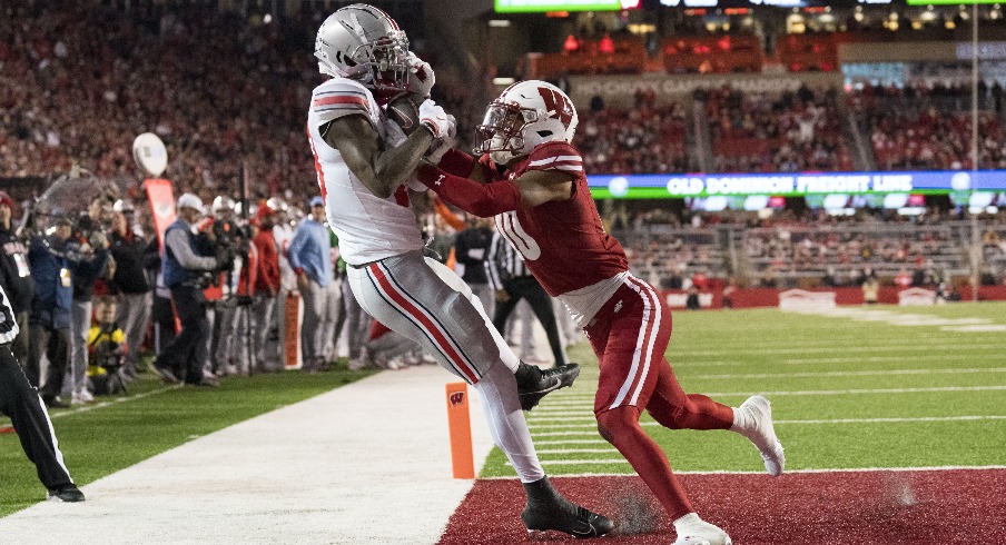 Oct 28, 2023; Madison, Wisconsin, USA; Ohio State Buckeyes wide receiver Marvin Harrison Jr. (18) catches a pass to score a touchdown as Wisconsin Badgers cornerback Nyzier Fourqurean (10) defends during the third quarter at Camp Randall Stadium. Mandatory Credit: Jeff Hanisch-USA TODAY Sports