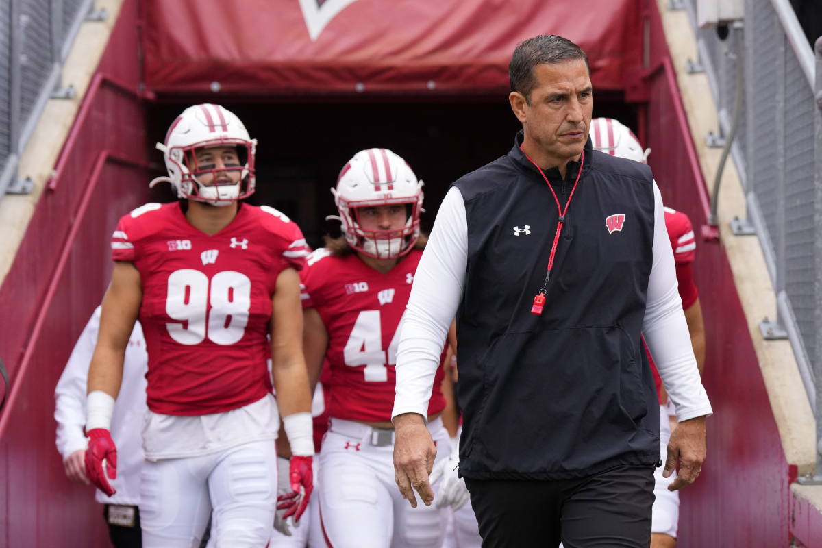 Oct 14, 2023; Madison, Wisconsin, USA; Wisconsin Badgers head coach Luke Fickell leads the football team onto the field for warmups prior to the game against the Iowa Hawkeyes at Camp Randall Stadium. Mandatory Credit: Jeff Hanisch-USA TODAY Sports