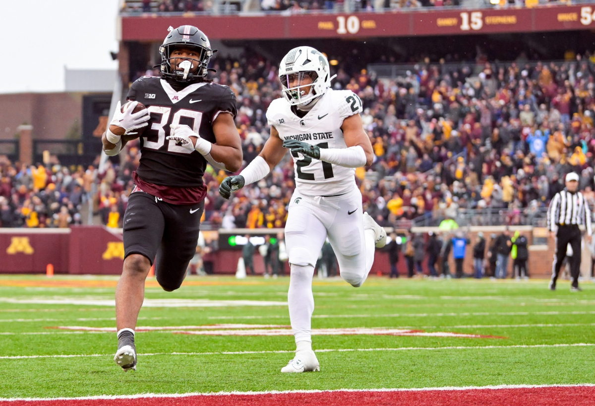 Oct 28, 2023; Minneapolis, Minnesota, USA; Minnesota Golden Gophers running back Jordan Nubin (30) scores a touchdown on a touchdown run as Michigan State Spartans defensive back Dillon Tatum (21) gives chase during the fourth quarter at Huntington Bank Stadium. Mandatory Credit: Nick Wosika-USA TODAY Sports
