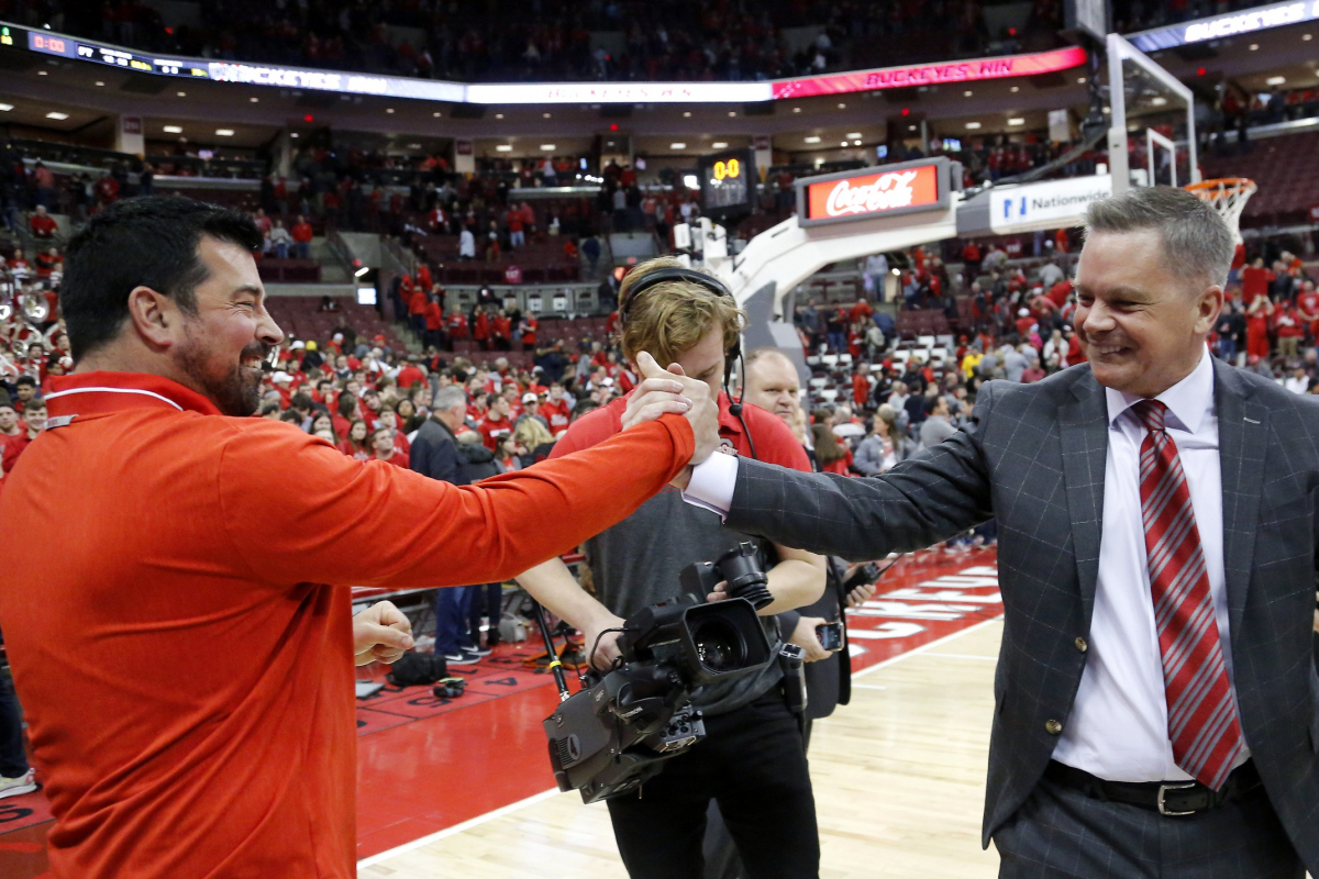 Mar 1, 2020; Columbus, Ohio, USA; Ohio State Buckeyes head coach Chris Holtmann (right) is congratulated by head football coach Ryan Day (left) following the second half against the Michigan Wolverines at Value City Arena. Mandatory Credit: Joseph Maiorana-USA TODAY Sports