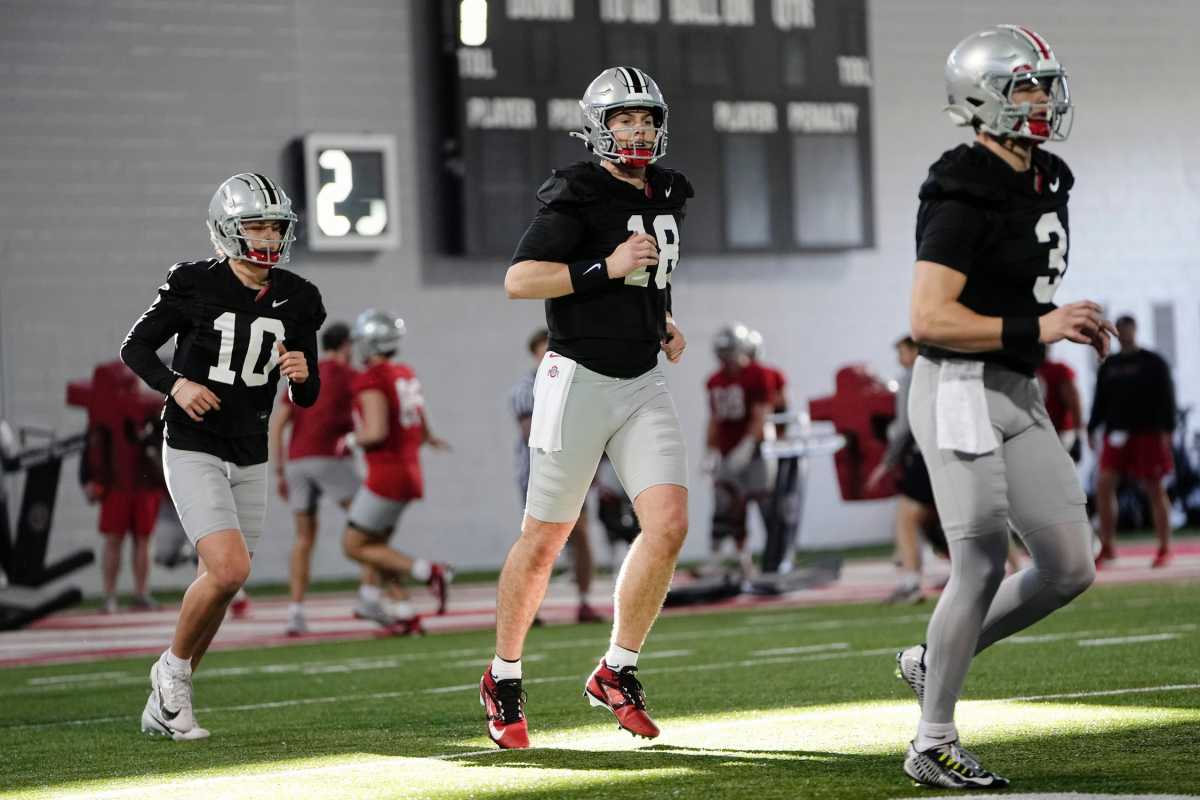 Mar 5, 2024; Columbus, OH, USA; Ohio State Buckeyes quarterbacks Lincoln Kienholz (3), Will Howard (18) and Julian Sayin (10) run during the first spring practice at the Woody Hayes Athletic Center.