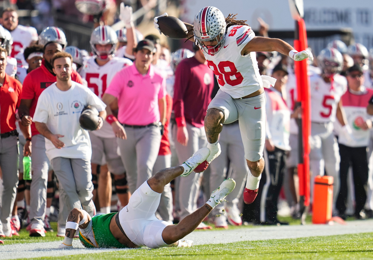 Ohio State Buckeyes tight end Gee Scott Jr. (88) leaps for a first down during the first half of the College Football Playoff quarterfinal against the Oregon Ducks at the Rose Bowl in Pasadena, Calif. on Jan. 1, 2025. Ohio State Buckeyes tight end Gee Scott Jr. (88) leaps for a first down during the first half of the College Football Playoff quarterfinal against the Oregon Ducks at the Rose Bowl in Pasadena, Calif. on Jan. 1, 2025.