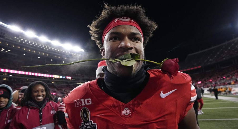 Caleb Downs leaves the field with a rose in his mouth following the 42-17 win over the Tennessee Volunteers in the College Football Playoff first round game at Ohio Stadium in Columbus on Dec. 21, 2024.