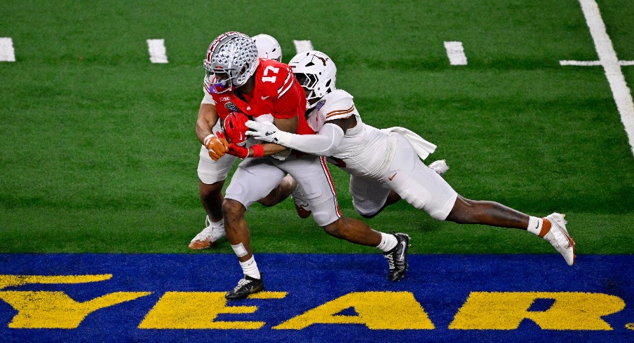 Jan 10, 2025; Arlington, TX, USA; Ohio State Buckeyes wide receiver Carnell Tate (17) and Texas Longhorns linebacker Anthony Hill Jr. (0) and linebacker Liona Lefau (18) in action during the game between the Texas Longhorns and the Ohio State Buckeyes at AT&T Stadium. Mandatory Credit: Jerome Miron-Imagn Images Jan 10, 2025; Arlington, TX, USA; Ohio State Buckeyes wide receiver Carnell Tate (17) and Texas Longhorns linebacker Anthony Hill Jr. (0) and linebacker Liona Lefau (18) in action during the game between the Texas Longhorns and the Ohio State Buckeyes at AT&T Stadium. Mandatory Credit: Jerome Miron-Imagn Images