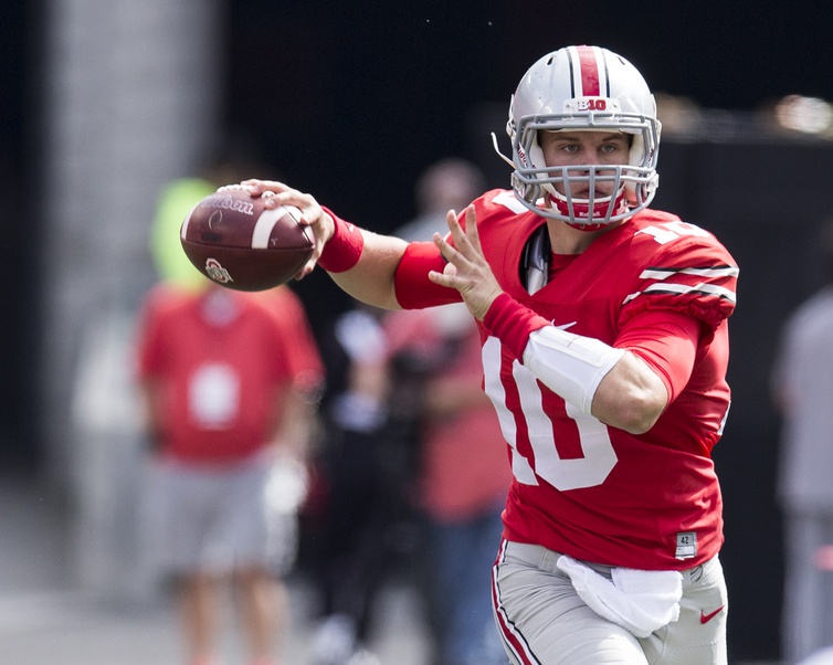 Oct 1, 2016; Columbus, OH, USA; Ohio State Buckeyes quarterback Joe Burrow (10) looks for an open receiver during the third quarter against the Rutgers Scarlet Knights at Ohio Stadium. Ohio State won the game 58-0. Mandatory Credit: Greg Bartram-Imagn Images