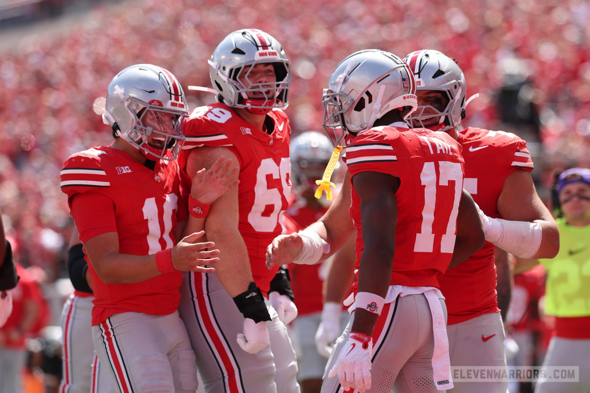 Carnell Tate celebrating his touchdown catch with teammates Carnell Tate celebrating his touchdown catch with teammates