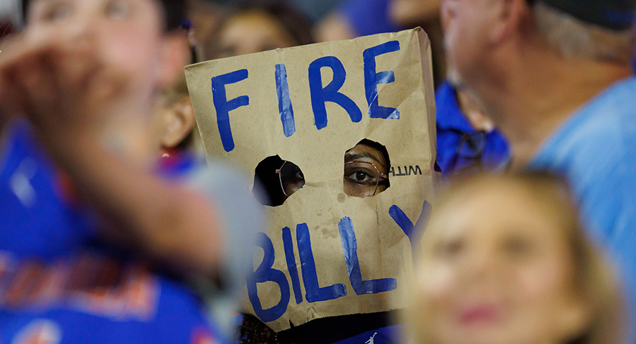A Florida Gator fan with a "Fire Billy" paper bag A Florida Gator fan with a "Fire Billy" paper bag