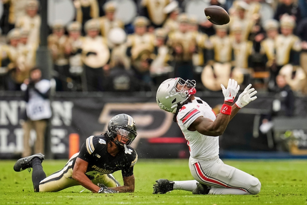 Ohio State Buckeyes wide receiver Jeremiah Smith (4) catches a ball in front of Purdue Boilermakers defensive back Hudauri Hines (4) during the NCAA football game at Ross-Ade Stadium in West Lafayette, Ind. on Nov. 8, 2025.