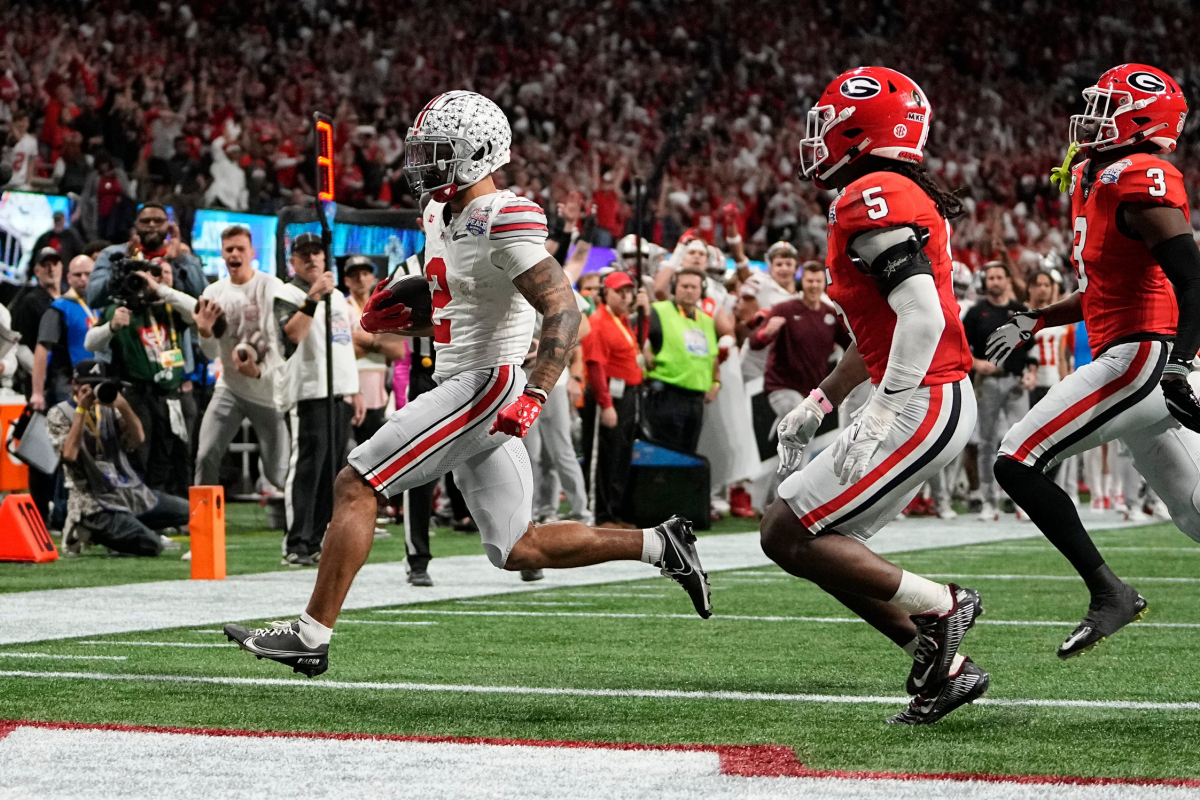 Dec 31, 2022; Atlanta, Georgia, USA; Ohio State Buckeyes wide receiver Emeka Egbuka (2) runs past Georgia Bulldogs defensive back Kelee Ringo (5) for a touchdown during the second half of the Peach Bowl in the College Football Playoff semifinal at Mercedes-Benz Stadium. Ohio State lost 42-41. Mandatory Credit: Adam Cairns-The Columbus Dispatch Ncaa Football Peach Bowl Ohio State At Georgia