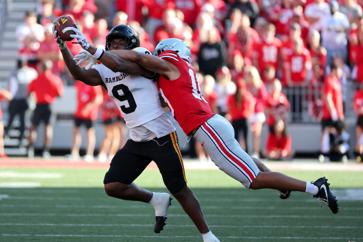 Sep 6, 2025; Columbus, Ohio, USA; Grambling State Tigers tight end Covadis Knighten (9) catches the ball as Ohio State Buckeyes safety Faheem Delane (10) makes the tackle during the third quarter at Ohio Stadium. Mandatory Credit: Joseph Maiorana-Imagn Images