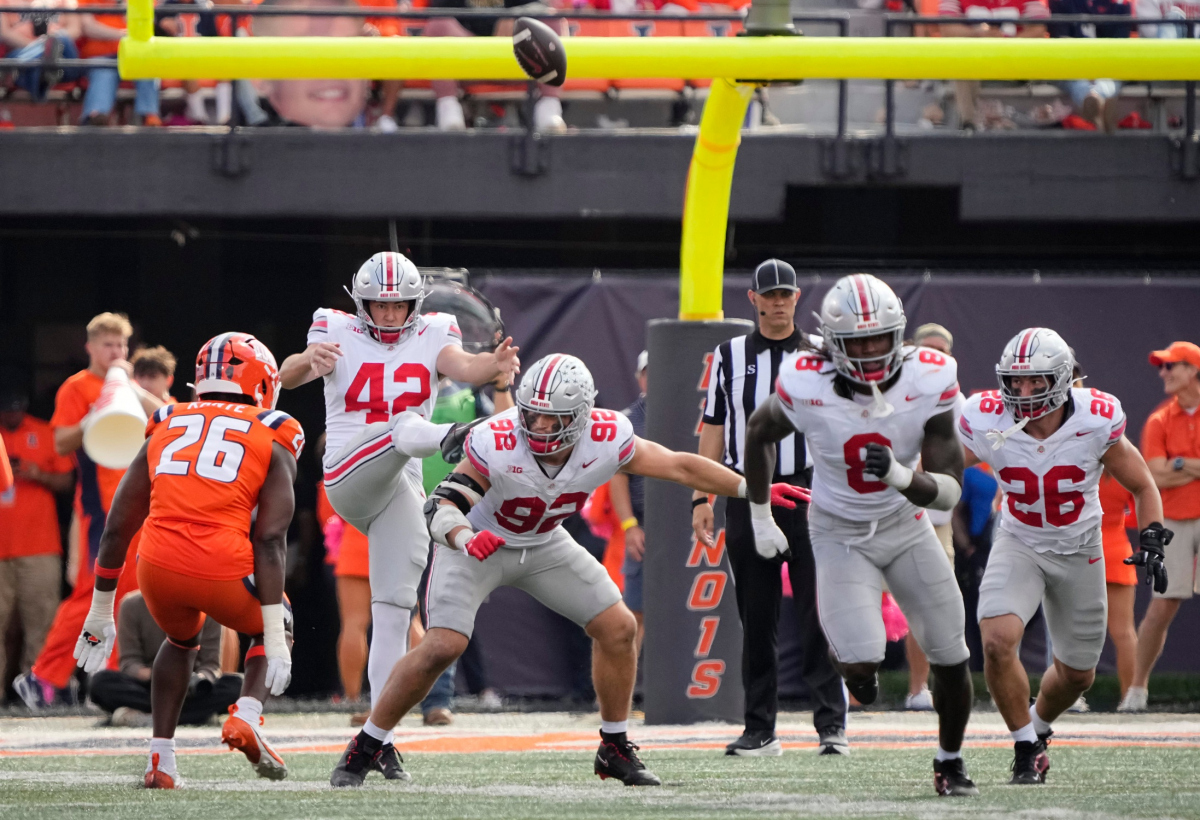 Ohio State Buckeyes punter Joe McGuire (42) punts during the second half of the NCAA football game against the Illinois Fighting Illini at Gies Memorial Stadium in Champaign on Oct. 11, 2025. Ohio State won 34-16.