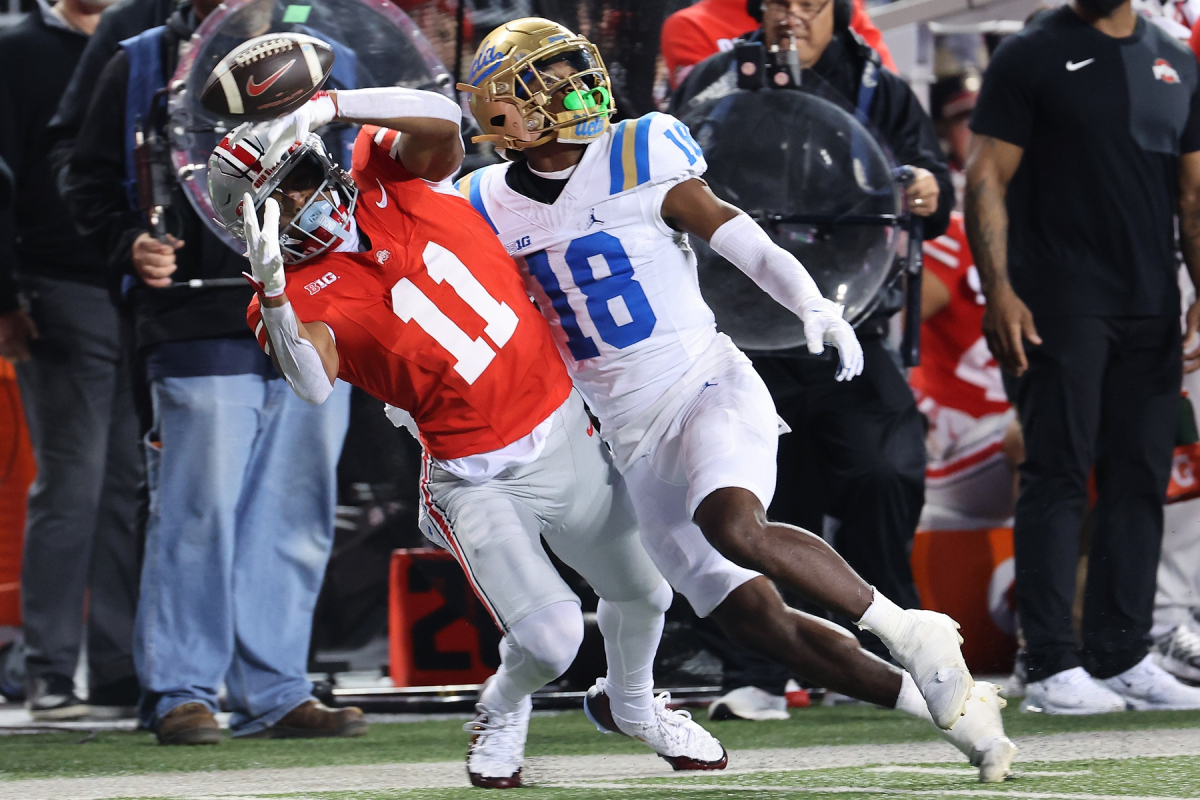 Nov 15, 2025; Columbus, Ohio, USA; Ohio State Buckeyes wide receiver Quincy Porter (11) attempts to catch the ball as UCLA Bruins defensive back Rodrick Pleasant (18) interferes on the play during the second quarter at Ohio Stadium. Mandatory Credit: Joseph Maiorana-Imagn Images