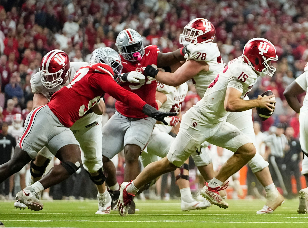 Indiana Hoosiers quarterback Fernando Mendoza (15) scrambles away from Ohio State Buckeyes defensive end Kenyatta Jackson Jr. (97) during the Big Ten Conference championship game at Lucas Oil Stadium in Indianapolis on Dec. 6, 2025. Ohio State lost 13-10.
