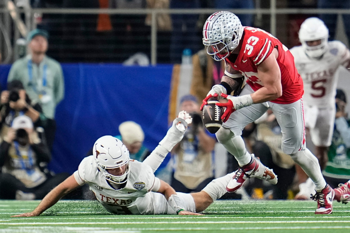 Ohio State Buckeyes defensive end Jack Sawyer (33) sacks Texas Longhorns quarterback Quinn Ewers (3) forcing a fumble during the second half of the Cotton Bowl Classic College Football Playoff semifinal game at AT&T Stadium in Arlington, Texas on Jan. 10, 2025. Sawyer returned the fumble for a touchdown, and Ohio State won 28-14.