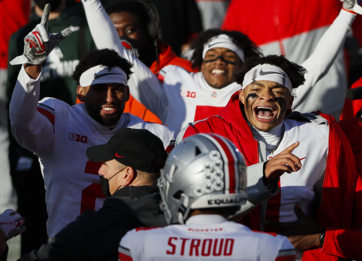 Ohio State Buckeyes quarterback Justin Fields (1) celebrates a rushing touchdown from fellow quarterback C.J. Stroud (14) during the fourth quarter of a NCAA Division I football game between the Michigan State Spartans and the Ohio State Buckeyes on Saturday, Dec. 5, 2020 at Spartan Stadium in East Lansing, Michigan.