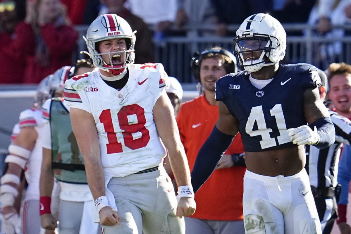 Ohio State Buckeyes quarterback Will Howard (18) celebrates a first down run beside Penn State Nittany Lions linebacker Kobe King (41) during the NCAA football game at Beaver Stadium in University Park, Pa. on Monday, Nov. 4, 2024. Ohio State won 20-13.